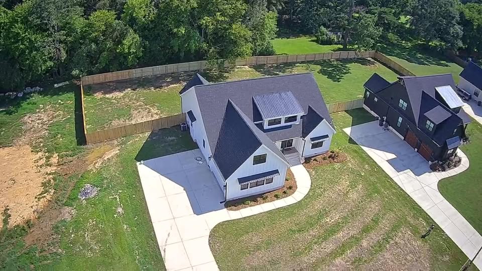 Aerial view of residential property with wood privacy fence
